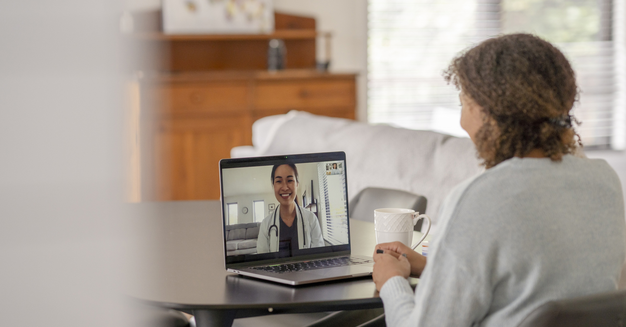 A woman having a virtual doctors appointment on her laptop